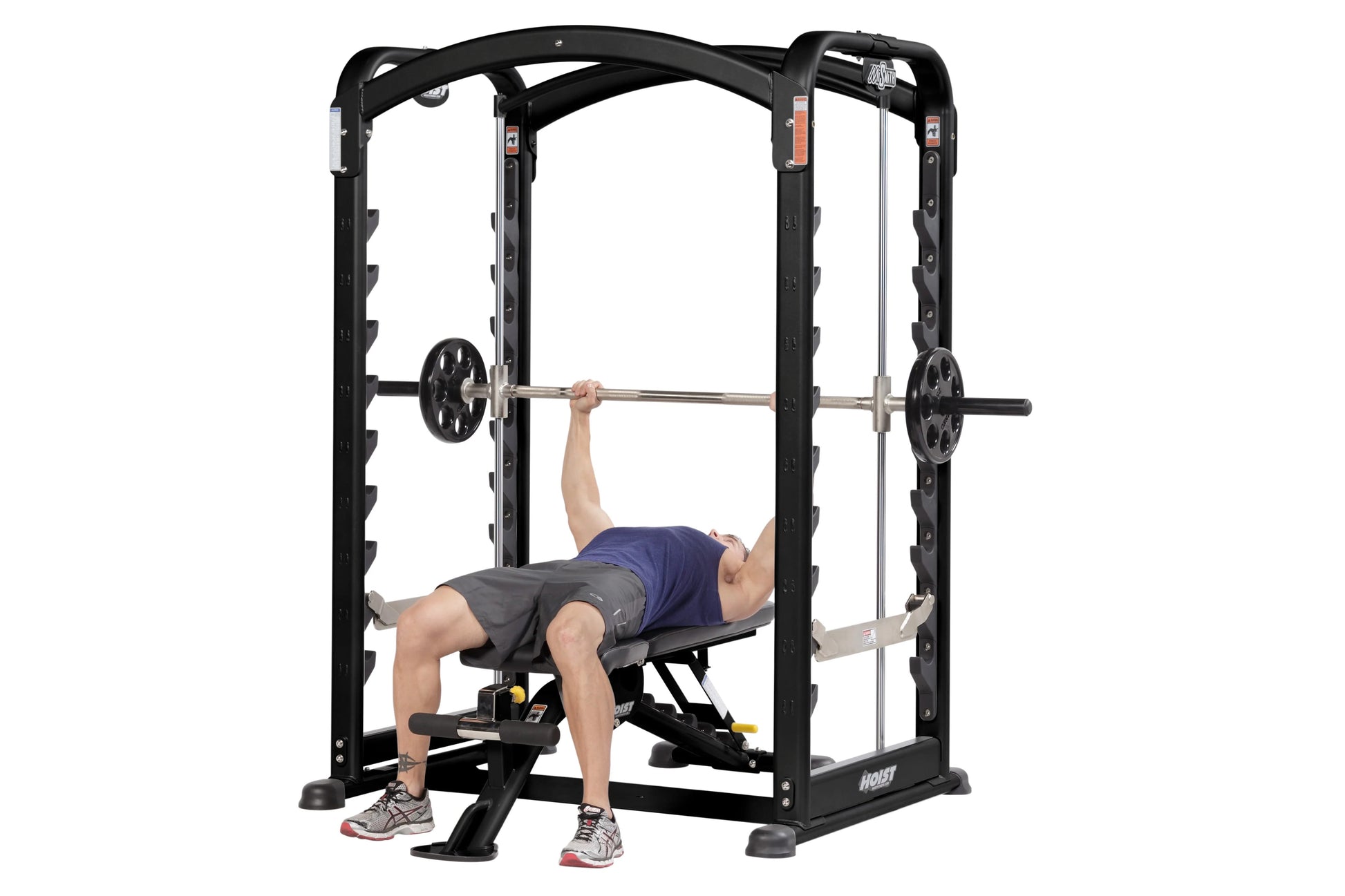 Black power rack smith machine with chrome barbell, worn by male model performing bench press exercise