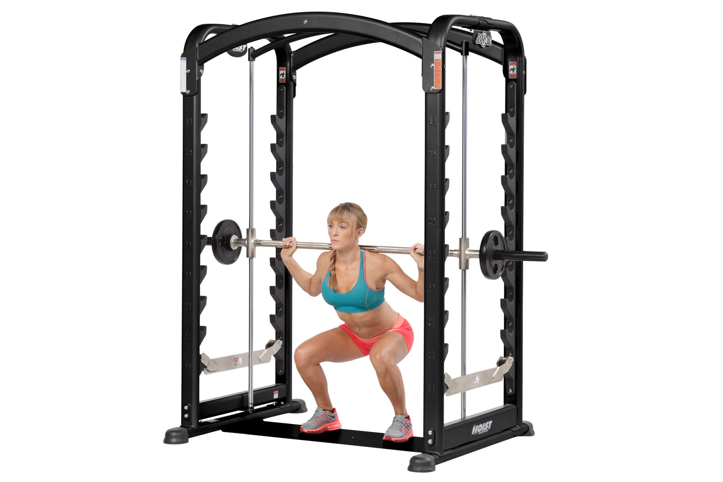Black dual action Smith machine with chrome barbell, worn by model performing squat exercise on white background