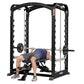 Black steel Smith machine with dual action rails, weight plates on barbell, and male model demonstrating bench press exercise