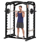 Black and silver Hoist Smith machine with dual action design, demonstrated by male model in navy tank top lifting barbell wit