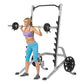 Woman using silver and black squat rack with barbell and weight plates, wearing purple sports bra and blue capri leggings