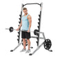 Male user demonstrating squat rack with barbell and weight plates, silver and black metal frame with dumbbell storage on whit