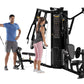 Black multi-gym with dual weight stacks and adjustable arms, shown with male and female models demonstrating cable exercises 