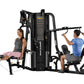 Hoist 2-Stack Multi Gym with black frame and yellow accents, demonstrating leg press and upper body exercises with two models