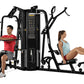 Black multi-station gym equipment with two exercisers demonstrating different exercises on white background