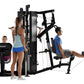 Black Hoist 4-Stack Multi Gym with multiple exercise stations, shown with three models demonstrating different exercises on w