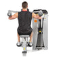 Male athlete using Hoist ROC-IT lateral raise machine, silver and black exercise equipment with dual handles, worn on white b