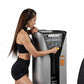 Woman in black sports bra and shorts using Hoist ROC-IT rotary calf machine with silver and black frame on white background