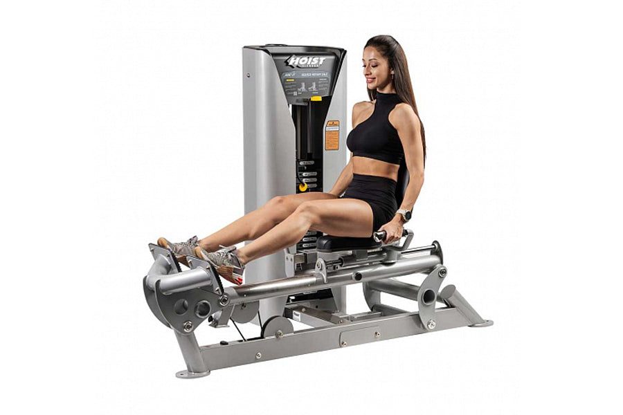 Hoist ROC-IT Rotary Calf Machine with silver and black frame, demonstrated by model in black sports bra and shorts