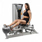 Woman using silver and black Hoist ROC-IT rotary calf exercise machine with leg extended on footplate