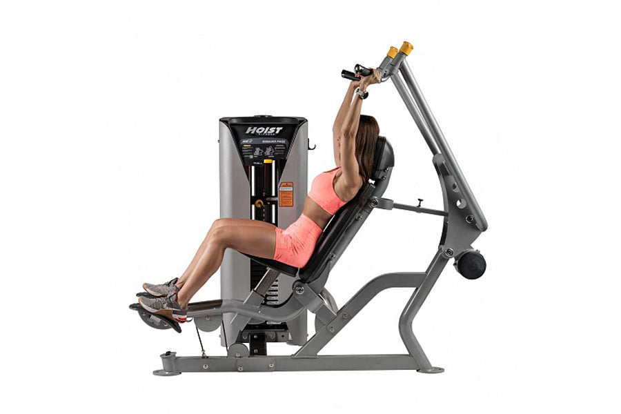 Woman using gray and black Hoist ROC-IT shoulder press machine with gold accents, demonstrated on white background