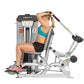 Woman using Hoist ROC-IT Triceps Extension Machine with silver frame and black seat, demonstrating triceps extension exercise
