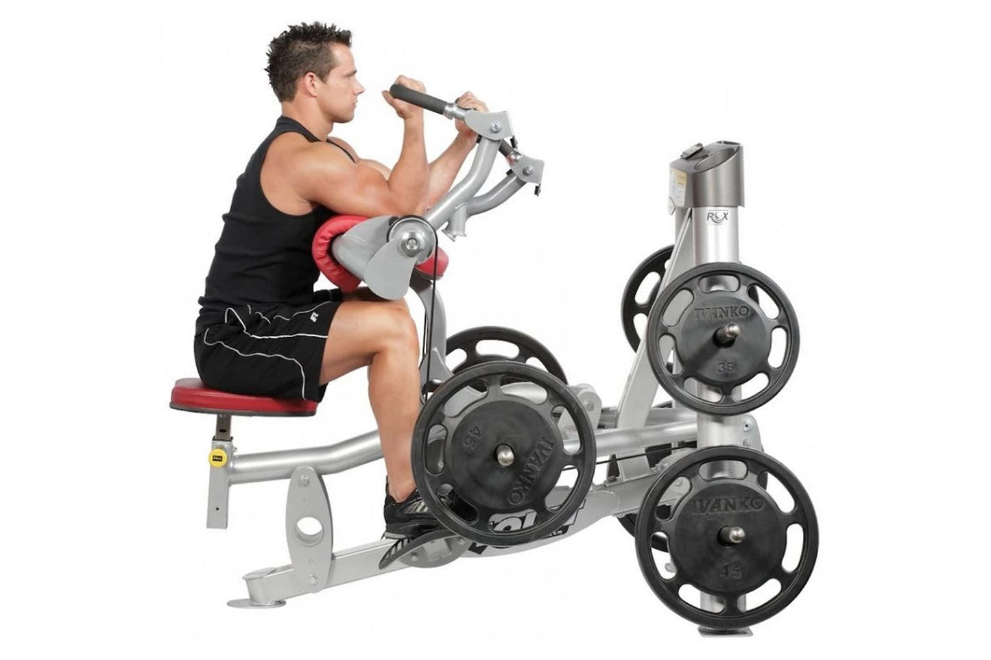 Man seated on silver and red exercise machine with black weight plates, performing biceps curl with handles