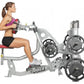 Woman in purple sports bra and black shorts using Hoist ROC-IT seated mid row machine with weight plates, shown in profile on