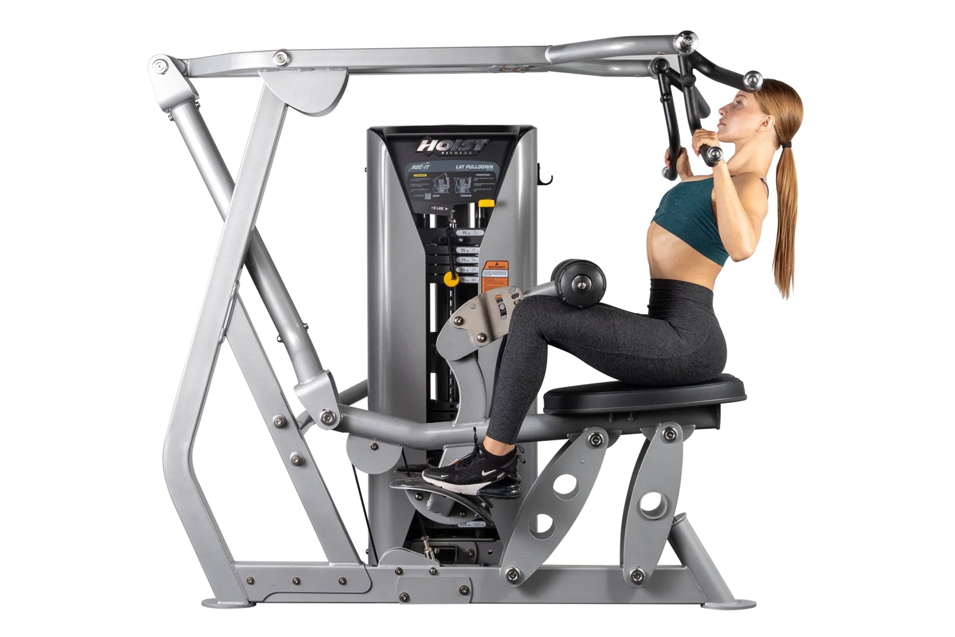 Hoist ROC-IT lat pulldown machine with silver frame and black control panel, worn by female model in teal sports bra and blac