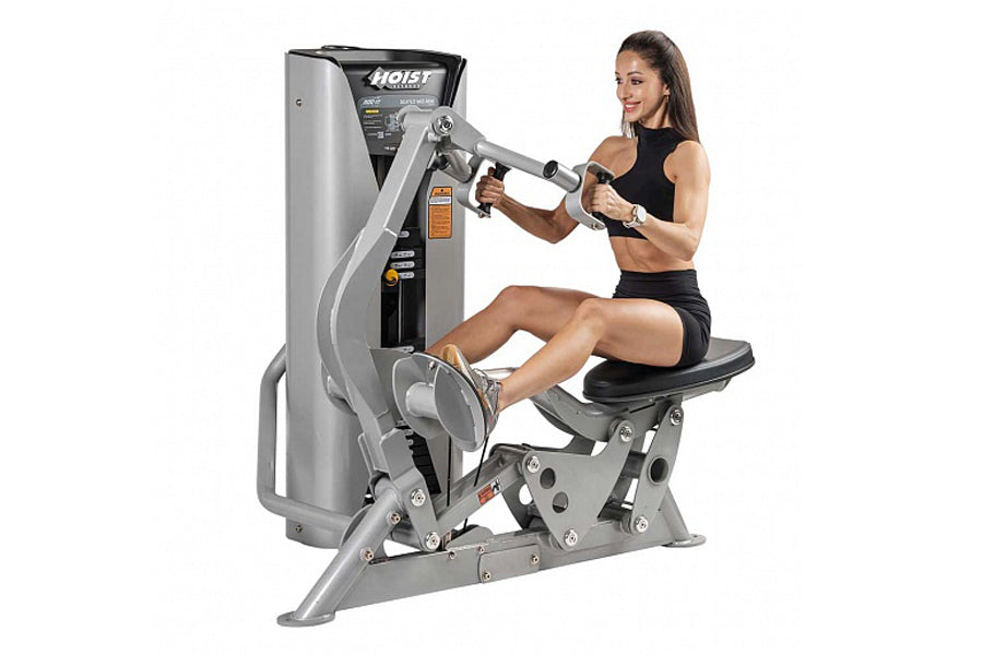 Hoist ROC-IT Seated Mid Row Machine in silver and black, demonstrated by woman in black tank top and shorts on white backgrou