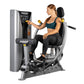 Hoist ROC-IT chest press machine with silver and black frame, woman in teal sports bra and black leggings demonstrating seate