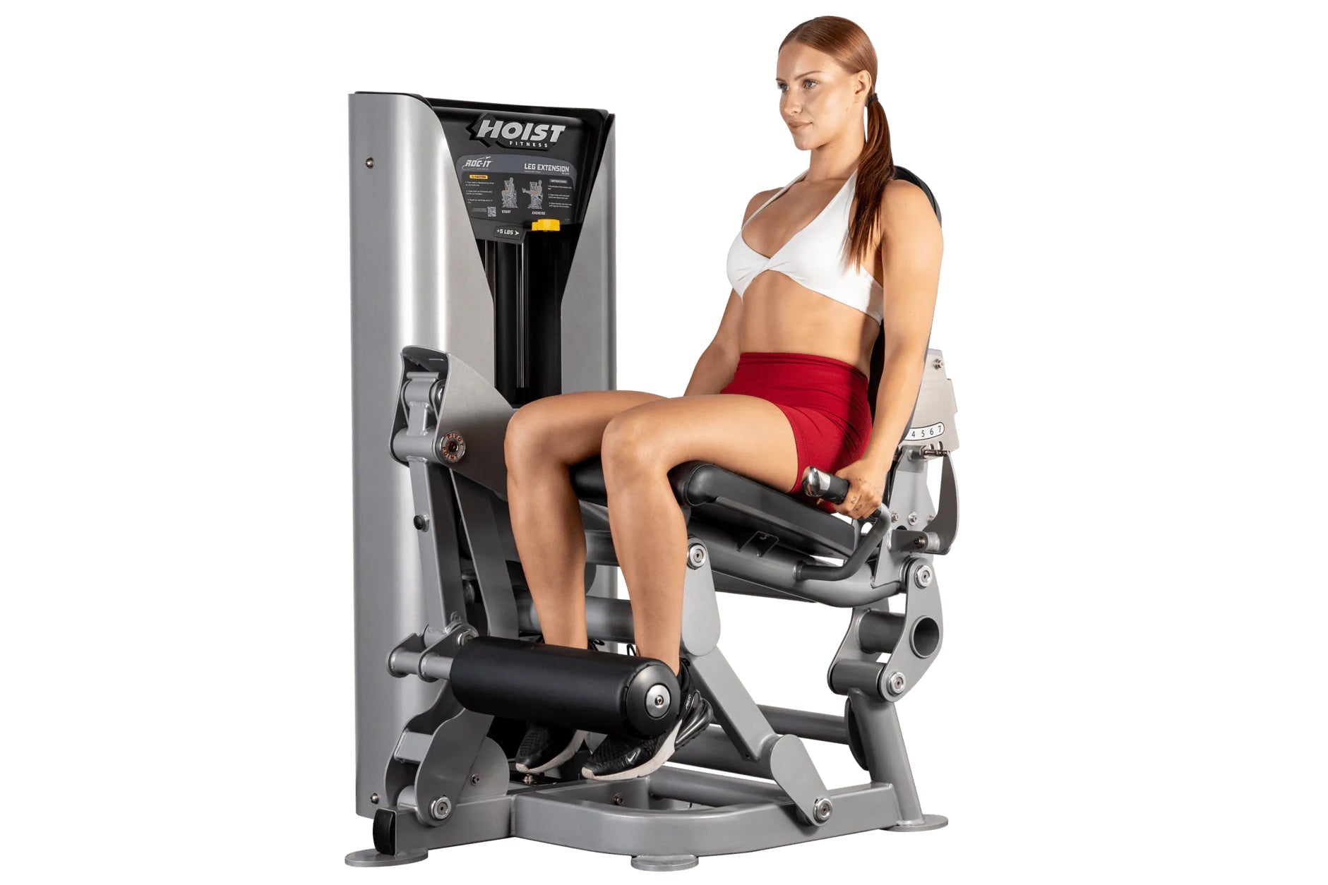 Woman using Hoist ROC-IT leg extension machine with silver and black frame, demonstrating seated leg exercise position