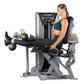 Woman using Hoist ROC-IT leg curl machine with silver and black frame, demonstrating leg extension exercise position