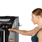 Woman in teal tank top using Hoist ROC-IT leg press machine with black and silver frame on white background