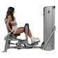 Woman using silver Hoist leg press machine with extended leg position on white background