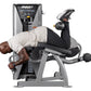 Man using Hoist ROC-IT prone leg curl machine with silver frame and black padding, holding dumbbell