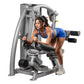 Woman in blue sports bra using silver and black Hoist ROC-IT Glute Master Machine with leg press attachment on white backgrou