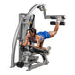 Hoist ROC-IT Glute Master Machine, silver-gray frame with black handles and footrests, woman in blue sports bra demonstrating