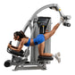 Woman in blue sports bra using gray Hoist ROC-IT Glute Master exercise machine with black seat and controls on white backgrou