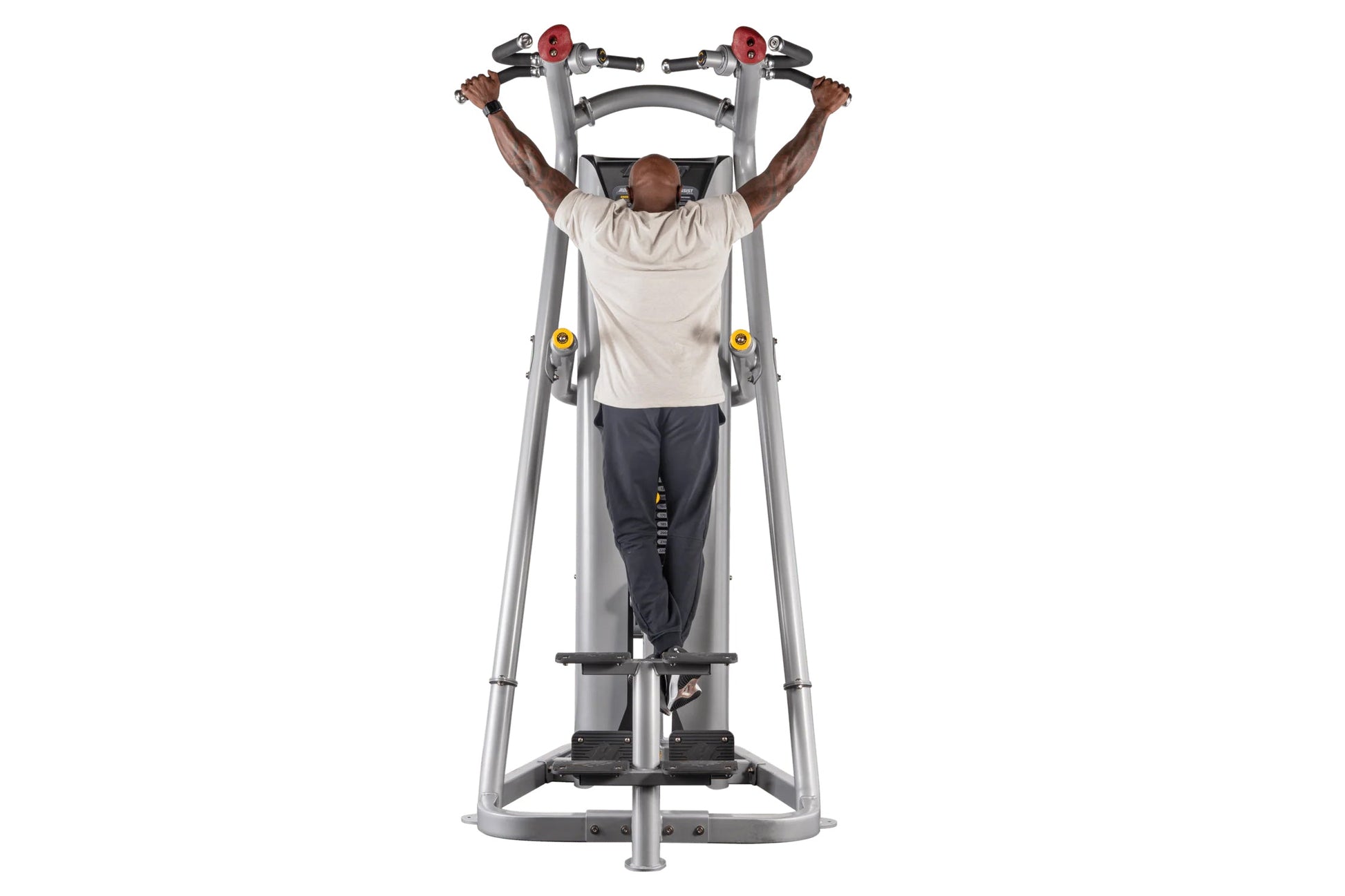 Man using gray Hoist ROC-IT Chin/Dip Assist Machine with red handles and yellow knobs on white background