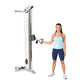 Woman demonstrating cable column exercise machine with pulley system and adjustable weights in silver and black finish