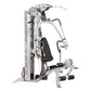 Silver and black multi-station home gym with lat pulldown, leg press, and chest press equipment on white background