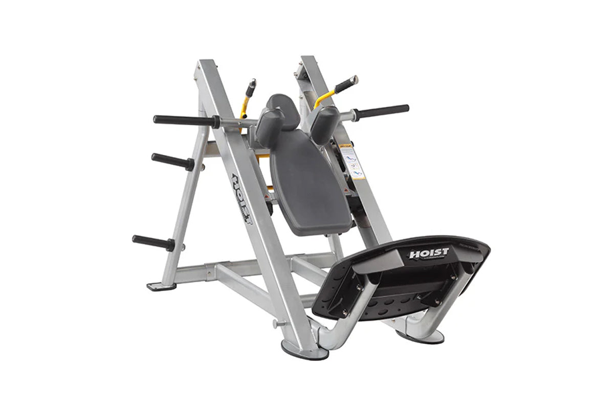 Hoist Hack Squat machine with silver frame, gray padded backrest, black handles, and footplate on white background