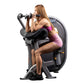 Woman in magenta sports bra using gray and black Hoist triceps extension machine on white background
