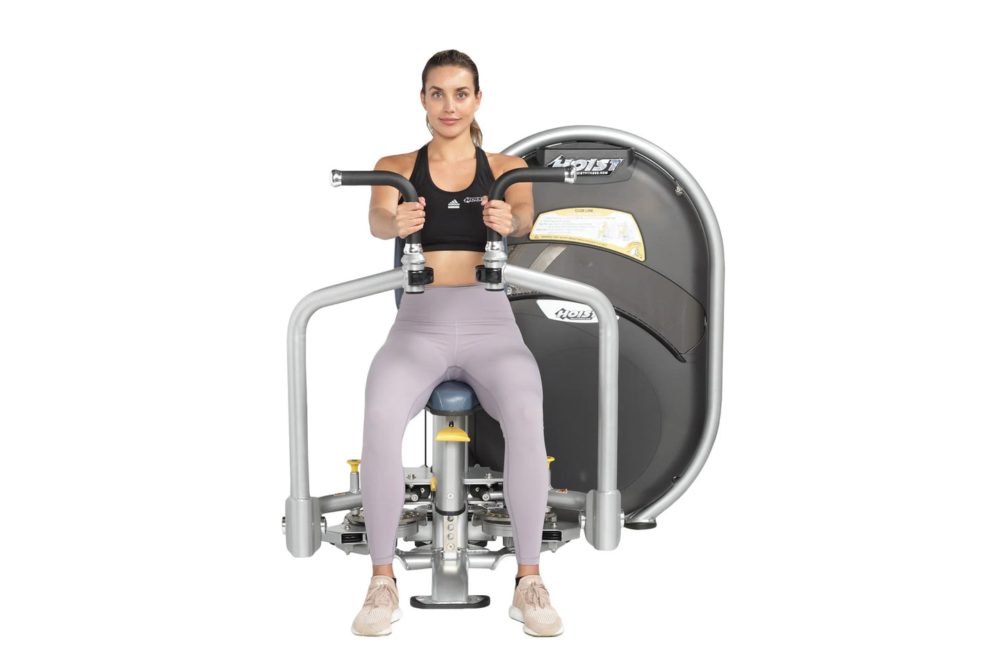 Woman wearing black sports bra and lavender leggings using Hoist Club Line Pec Fly/Rear Delt machine with gray frame and blac