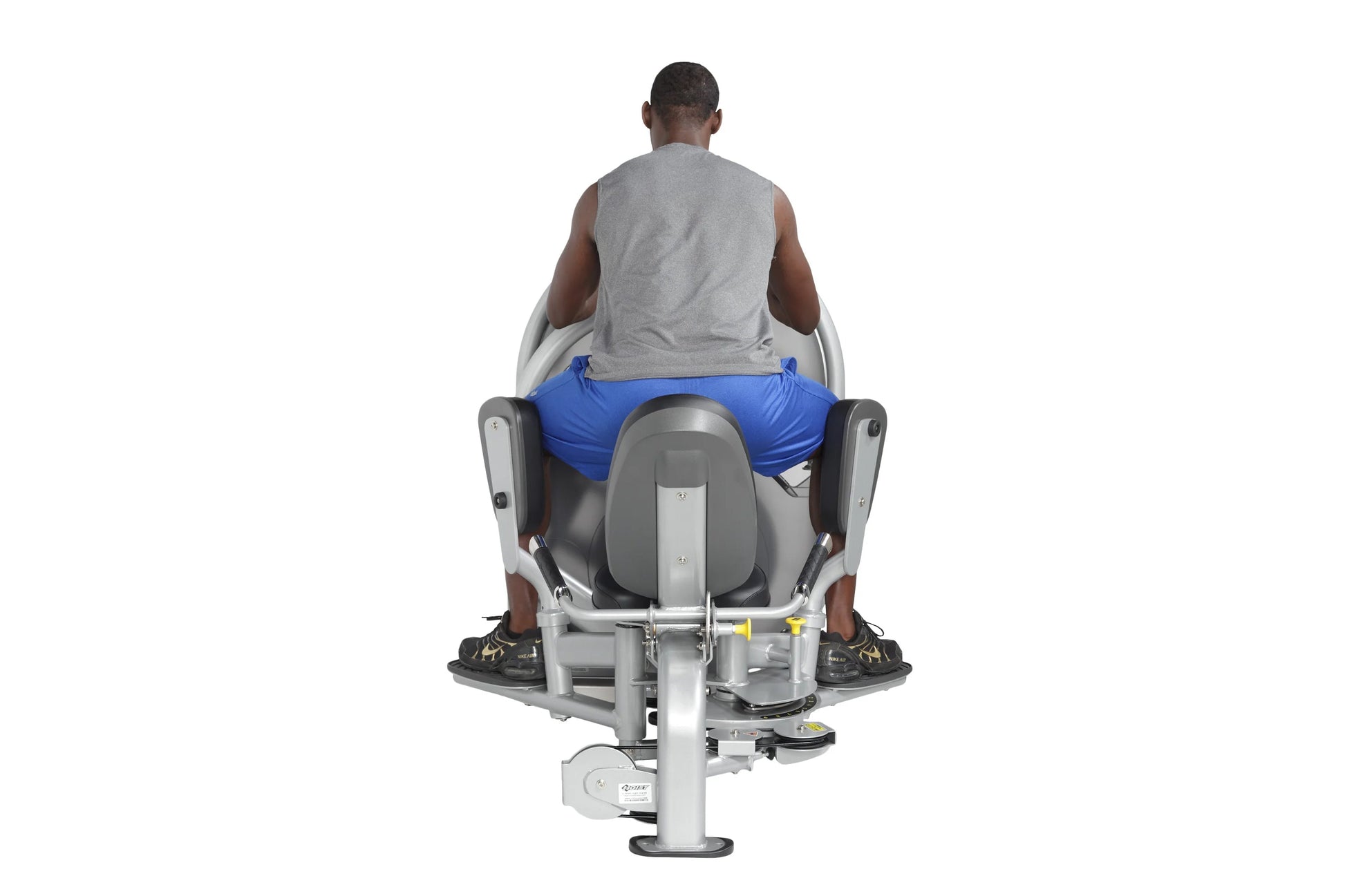 Man seated on gray and blue leg press machine viewed from behind, demonstrating proper thigh exercise form