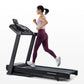 Woman running on black Horizon 5.0 AT treadmill wearing lavender sports bra and burgundy leggings, white sneakers