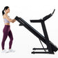 Woman in purple leggings and lavender sports bra using black Horizon 5.0 AT treadmill on white background