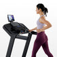 Woman in lavender tank top and burgundy leggings running on black Horizon 5.0 AT treadmill with digital display