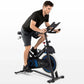 Man in black shirt and shorts riding Horizon 5.0 IC stationary bike with blue accents and digital display, on white backgroun