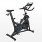 Black and blue indoor exercise bike with tablet holder and resistance dial, on white background