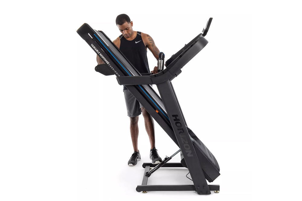 Man in black tank top using black Horizon treadmill with blue stripe accent on white background