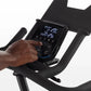 Horizon 7.0 IC indoor cycle console with digital display showing workout metrics, operated by hand on white background