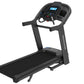 Black Horizon 7.4 AT treadmill with digital display console, cushioned running deck, and handlebar controls on white backgrou