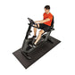 Horizon Comfort R recumbent exercise bike in gray and black with male model wearing orange shirt seated on equipment