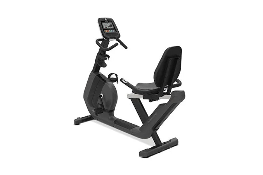 Black recumbent exercise bike with digital display console, padded seat, and sturdy frame base on white background