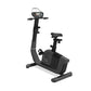 Black upright exercise bike with digital display console, handlebars, padded seat, and foot pedals on white background