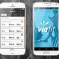 White iPhone and Samsung phones displaying fitness app workout history and Viafit logo on wooden background