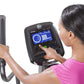 Woman in pink top using Horizon Evolve 5 elliptical with digital touchscreen console display