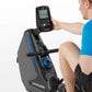 Man in blue shirt using Horizon Oxford 3 rowing machine with digital display console, gray and black machine with blue accent